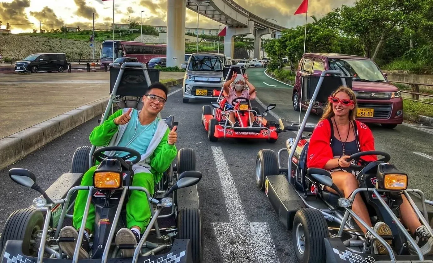 Karts passing beneath a concrete overpass on the road out to the airport