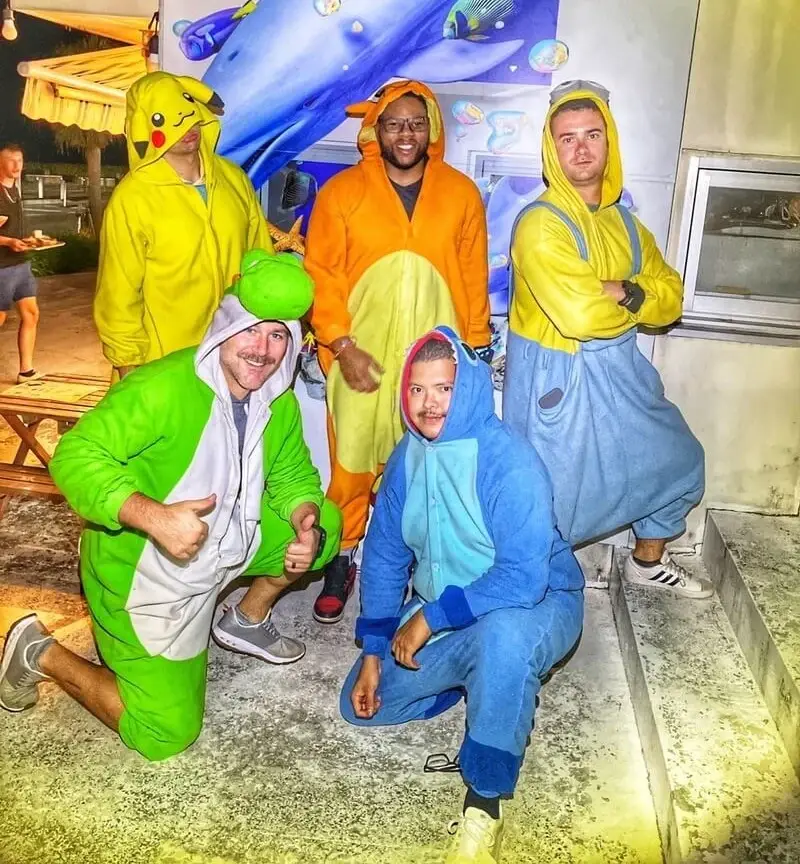 A group in Pikachu and Stitch onesies posing together before setting off
