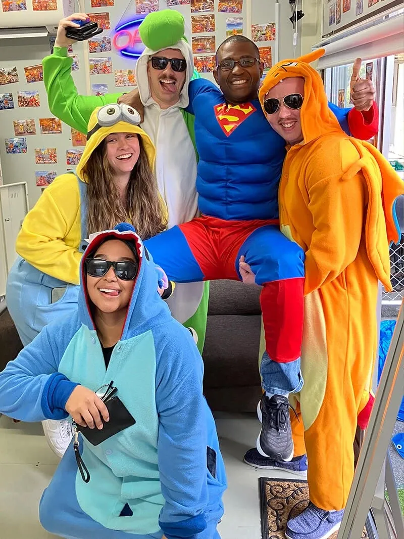 A group in superhero and animal cosplay gathered inside the shop