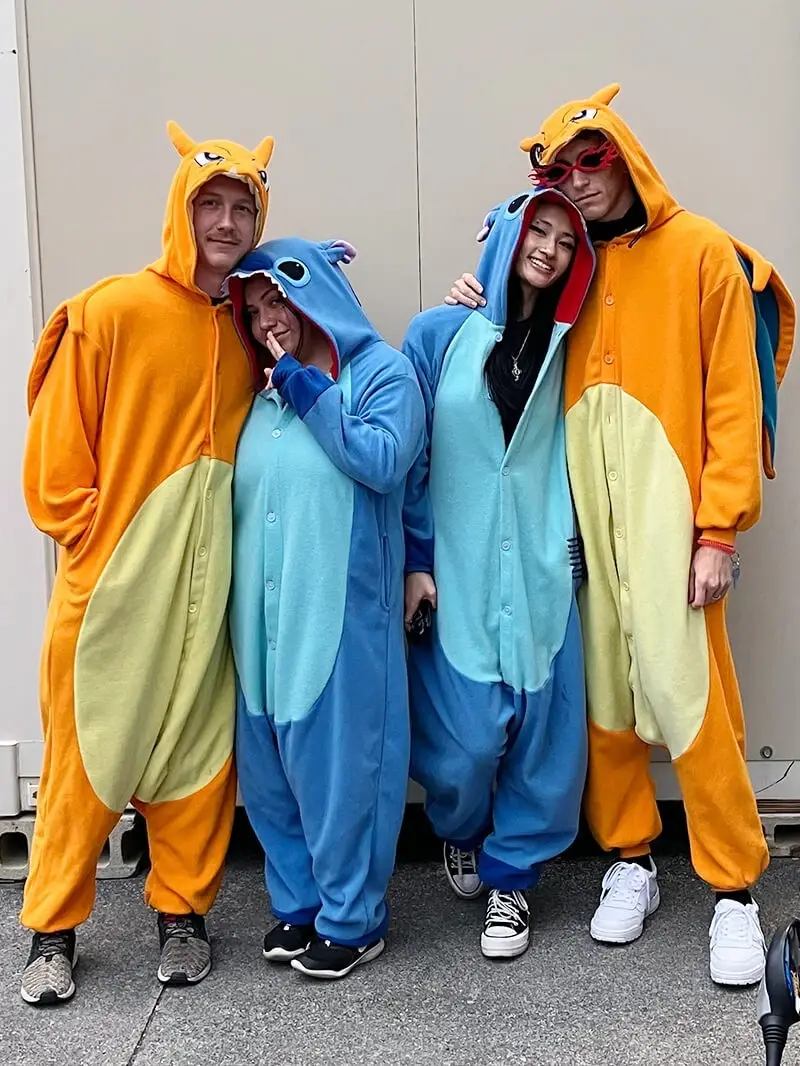 Four riders in kigurumi cosplay outside the shop before the briefing