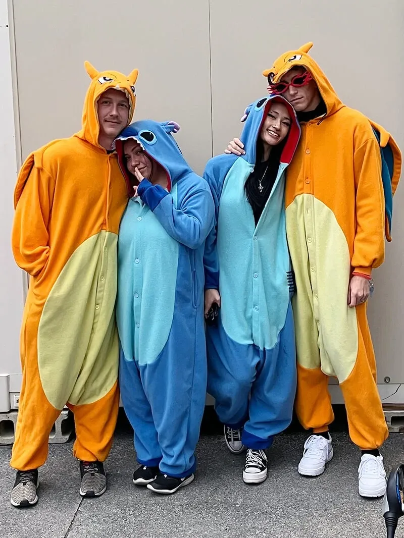 Four riders in kigurumi cosplay outside the shop before the briefing