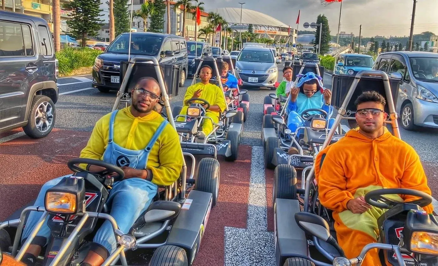 Riders in yellow and orange cosplay driving through downtown Naha traffic